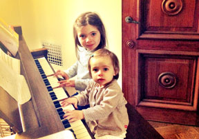 YOUNG PIANISTS: Sam Koule with sister Neve at the piano. 