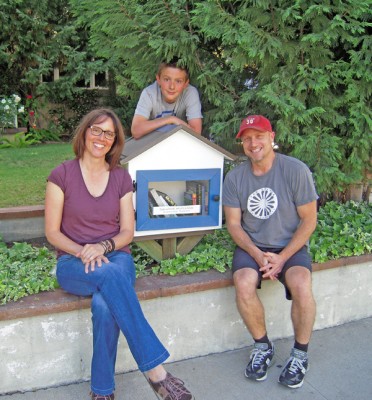 Wendy Hopkins, pictured with husband Boyd Hale and son, Hop, built the little library in front of the family's home on N. Gower. 