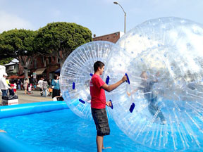 KIDS FLOAT on water in giant bubbles.