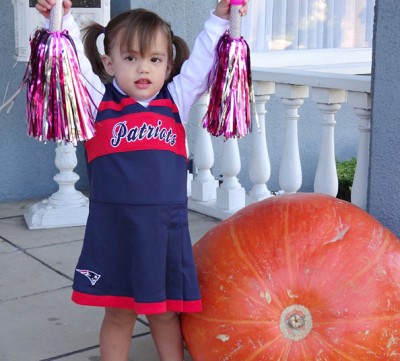 HIS LITTLE SISTER, Kelsey, cheered him on in a Patriot's cheerleader's outfit.