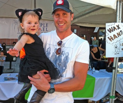 HITCHING A RIDE from her dad Chuck Whitman at last year's Larchmont Family Fair was Matisse Whitman-McChesney dressed as a kitten.