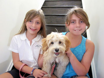 SHOWN WITH their dog Ginger are columnist’s daughters, from left, Amelia and Isabella. 