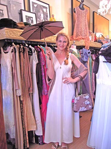 MODELING a Penelope parasol and a M. Andonia handbag is Beth LaMure at her new shop in Larchmont Village.