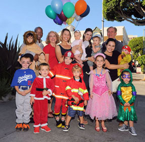 READY FOR the Larchmont Family Fair on Sun., Oct. 26 are, bottom row, Henry Hoegee, Nicholas Wright, Jake Juno-Kasofsky, Tar Rogan, Rita Wright, Hadley Levin; second row, Clyde Jenkins with Jason Arrowsmith, Michelle Hanna, Monica Rogan with Lainey,  Abby Aran with Max, John Winther, and Melissa Levin holding Briggs.                        Story page 7,  Photo by Bill Devlin         