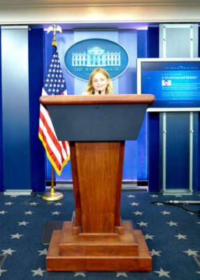 Sadie stands at the podium where President Obama presides. 