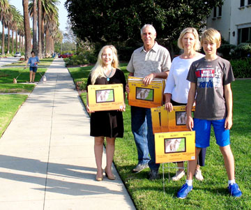 “COYOTE ALERT” lawn signs were distributed last month by local association representatives. Pictured are Julie Stromberg of Windsor Village and Steve Tator, Angie Szentgyorgyi and Lucas Szentgyorgyi of Windsor Square. 