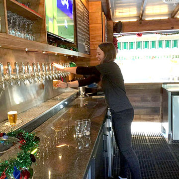 BARTENDER Laura Case pours one of 24 craft beers on draft.