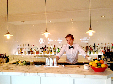 MIXOLOGIST Chris Kramer shakes and stirs exotic drinks behind the bar at the Larchmont. 