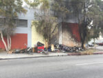Encampment fire on Third Street chars wall